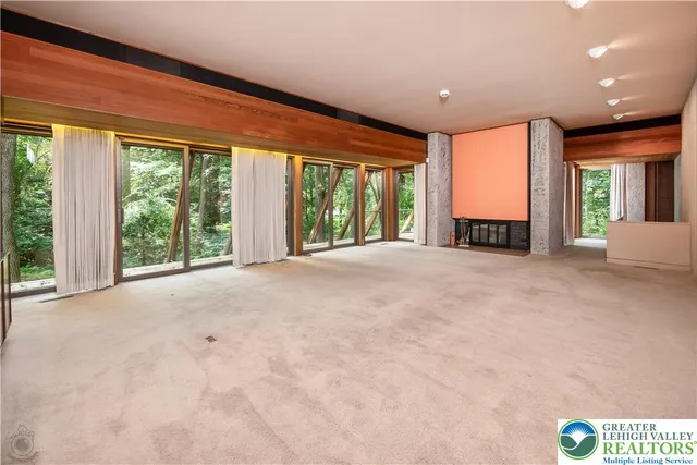 a view of a room with wooden floor and outdoor space
