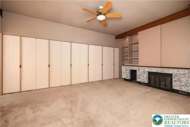 a view of an empty room with a fireplace