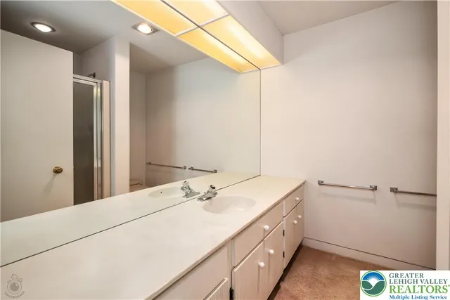 a view of an empty room with a fireplace and a large window