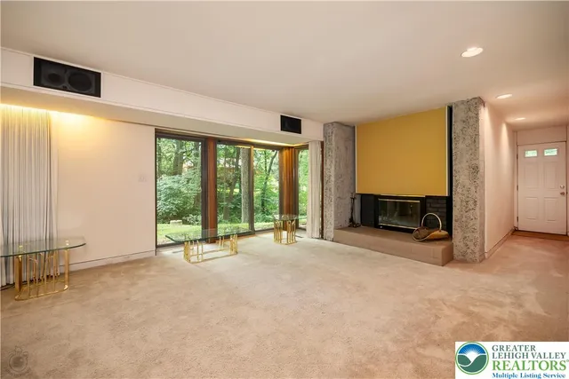 a view of a porch with furniture and floor to ceiling window