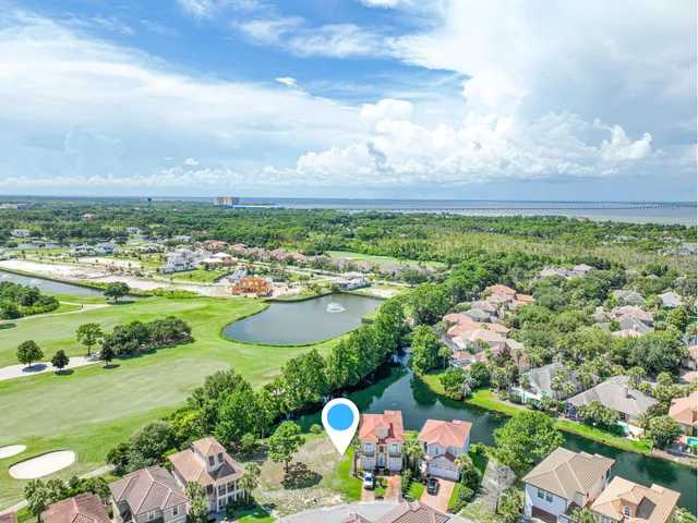 an aerial view of residential building and lake