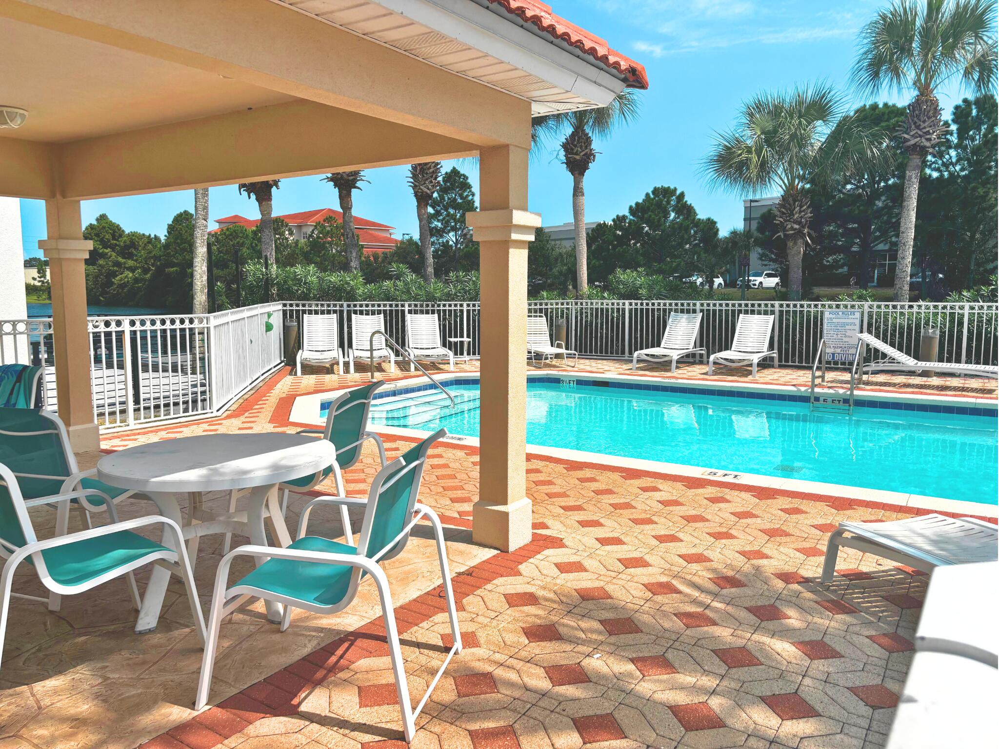 258 Calusa Boulevard Destin, FL 32541 - Photo 20 of 21 a patio with wooden floor table and chairs
