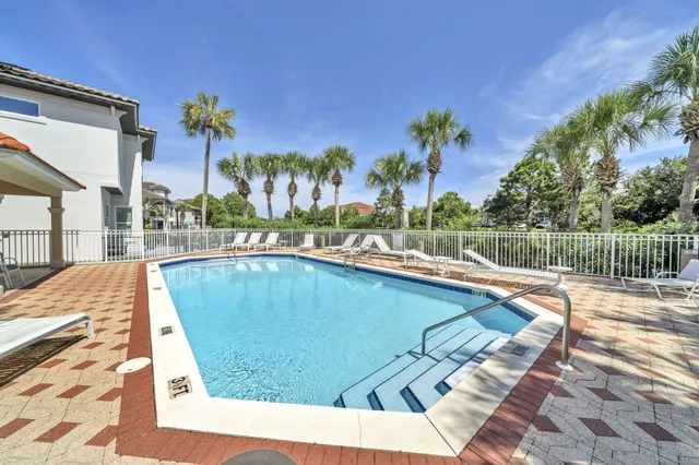 a view of swimming pool with a lounge chairs