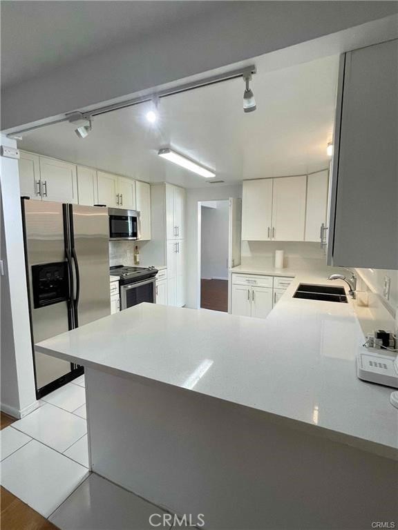 2001 Rancho Drive Riverside, CA 92507 - Photo 4 of 10 a kitchen with refrigerator and cabinets