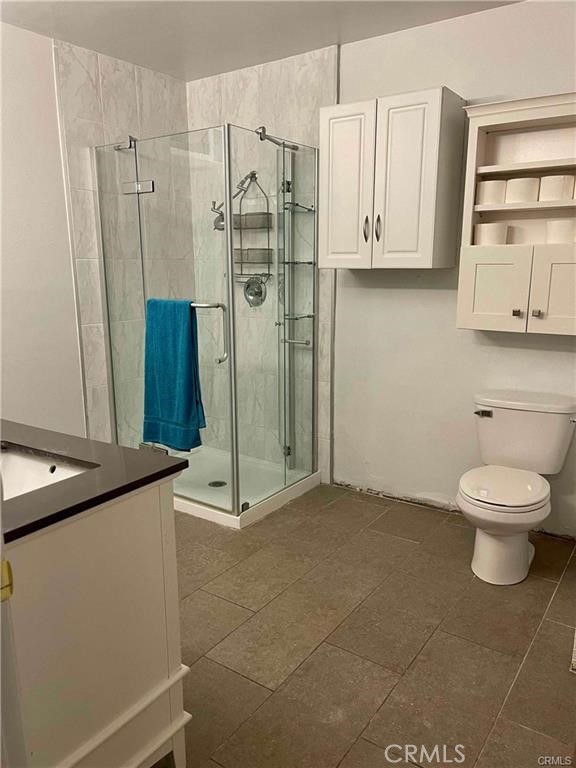 2001 Rancho Drive Riverside, CA 92507 - Photo 6 of 10 a bathroom with a granite countertop sink a toilet and a shower