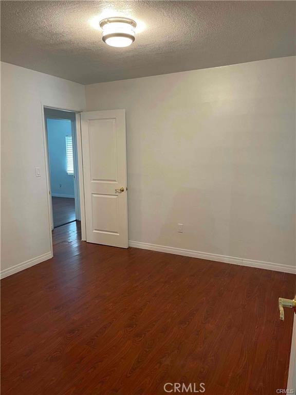 2001 Rancho Drive Riverside, CA 92507 - Photo 8 of 10 an empty room with wooden floor and windows