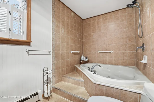 a bathroom with a bathtub and a shower