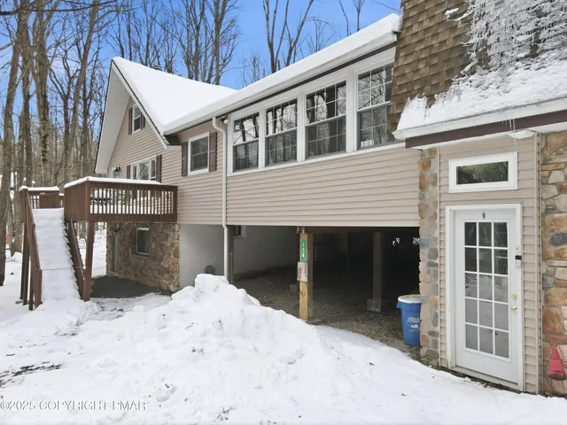 a living room with fireplace furniture and a large window