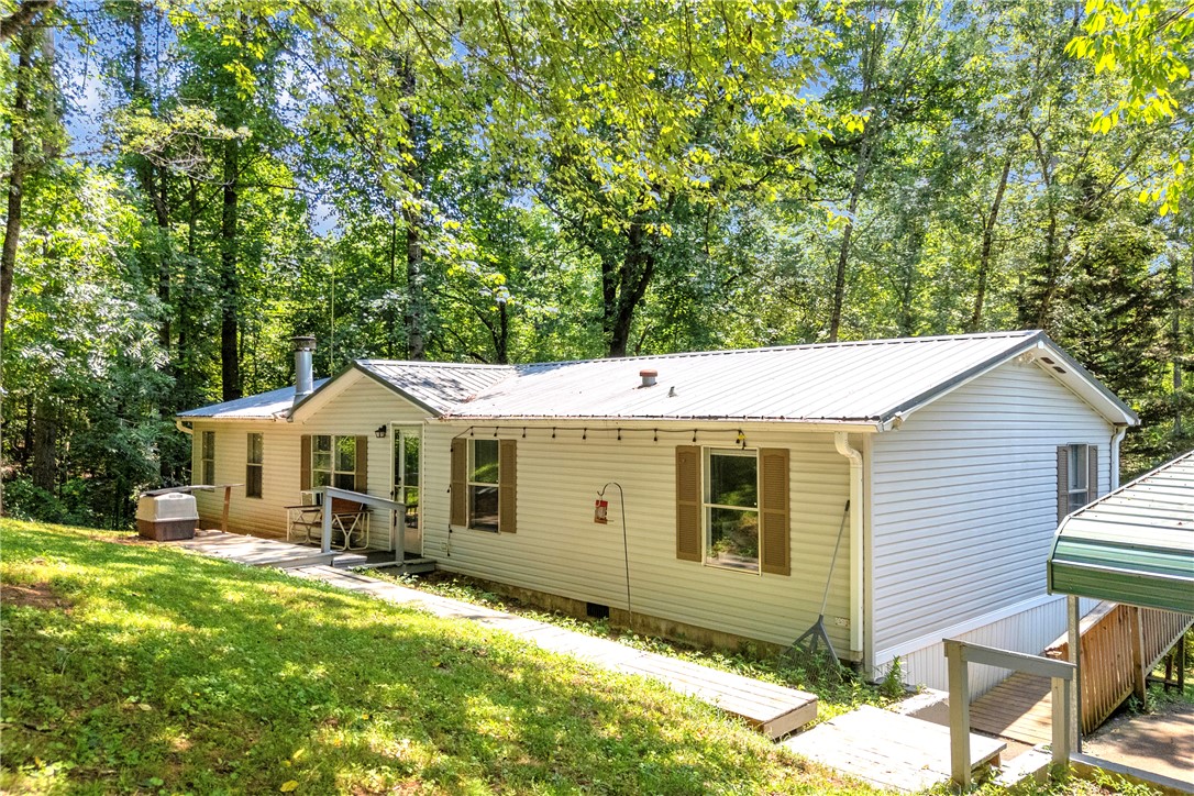162 Newberry Road Walhalla, SC 29691 - Photo 44 of 50 A quaint residence nestled among verdant trees offers a serene natural setting.