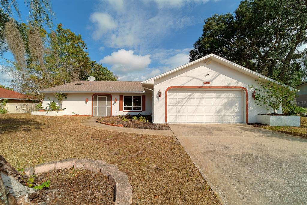 6418 India Drive Spring Hill, FL 34608 - Photo 1 of 1 a front view of a house with a yard and garage