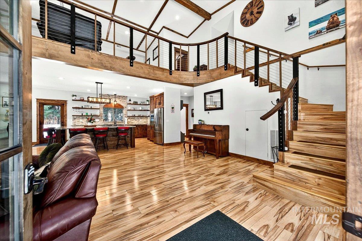 292 Rio Vista Boulevard McCall, ID 83638 - Photo 3 of 50 Living room featuring light wood-finish laminate flooring, recessed lighting, and a soaring ceiling