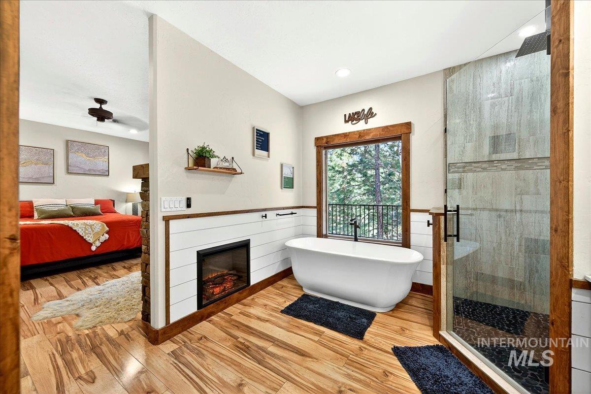 292 Rio Vista Boulevard McCall, ID 83638 - Photo 33 of 50 Ensuite bathroom with tile shower, a soaking tub, and fireplace
