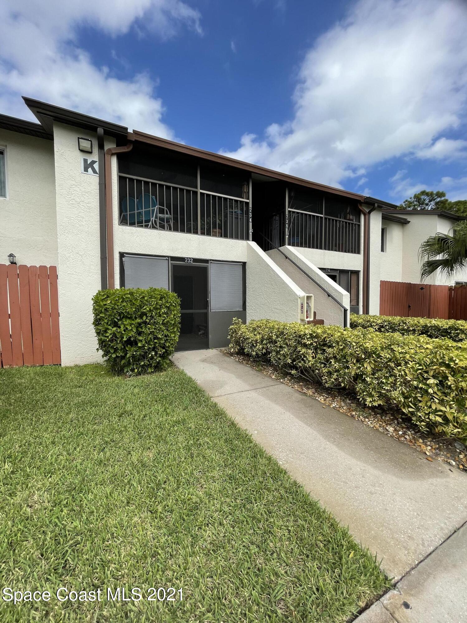 732 Ridge Club Drive, Unit 49 Melbourne, FL 32934 - Photo 14 of 17 a front view of a house with a yard