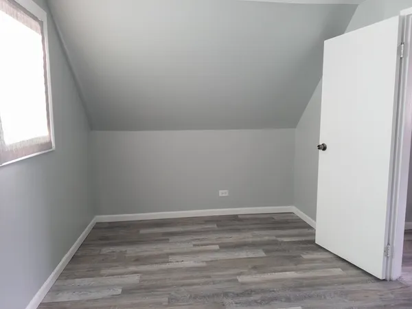 a view of a room with wooden floor