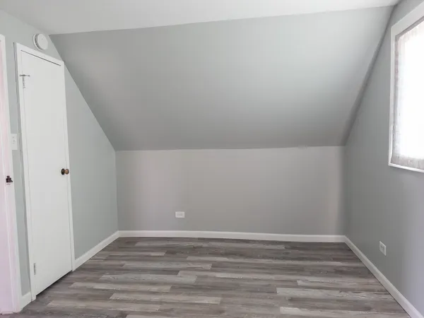 a view of room with window and hardwood floor
