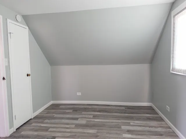 a view of room with window and hardwood floor