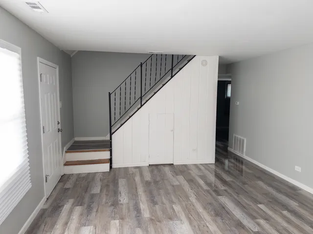 a view of entryway and hall with wooden floor