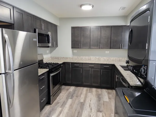 a kitchen with a refrigerator stove and microwave