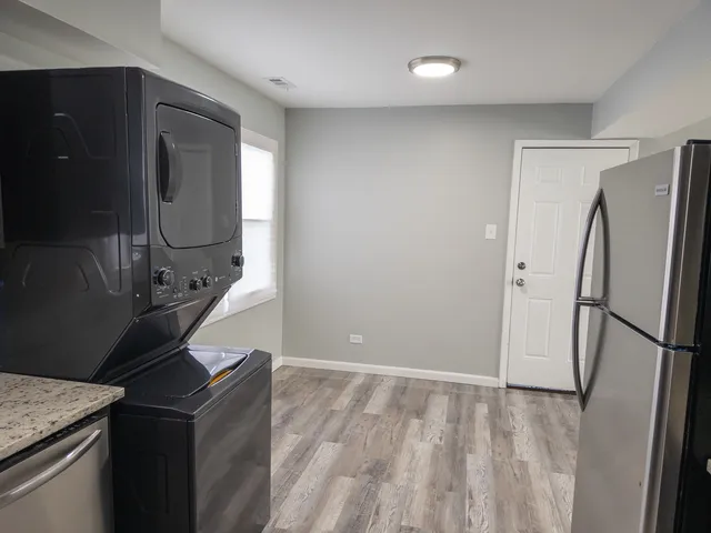 a kitchen with stainless steel appliances granite countertop a refrigerator a stove and a refrigerator