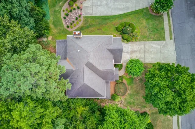 a view of a chair and table in backyard of the house