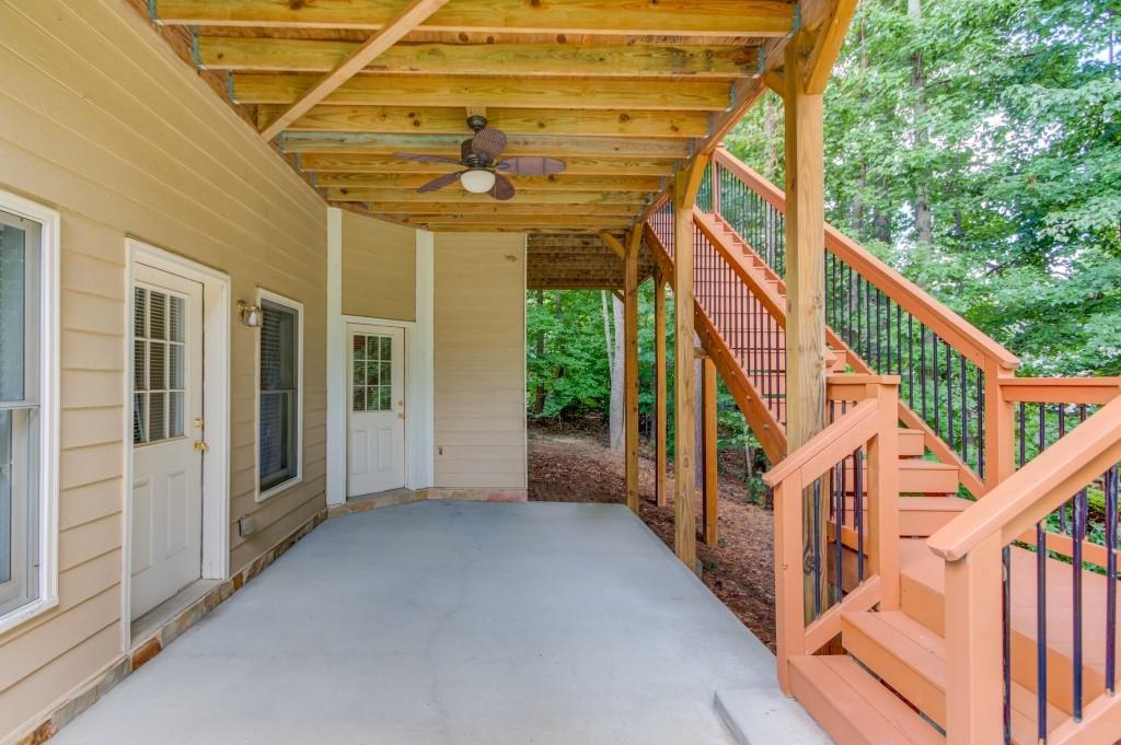 2405 Millwater Crossing Northeast Dacula, GA 30019 - Photo 16 of 63 a view of a porch with wooden floor and stairs