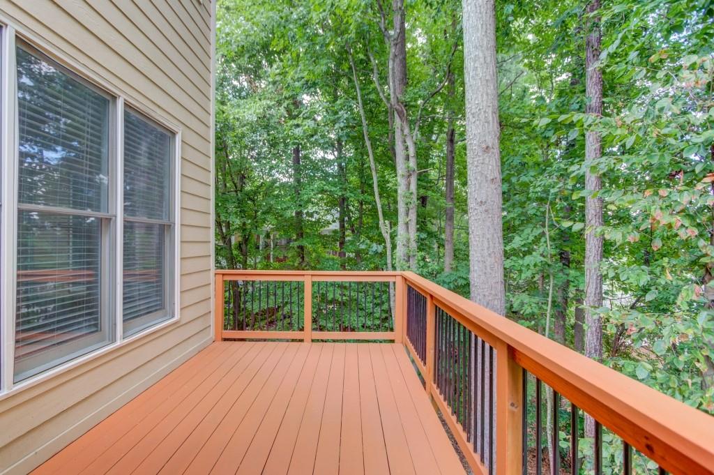 2405 Millwater Crossing Northeast Dacula, GA 30019 - Photo 18 of 63 a view of balcony with deck and trees