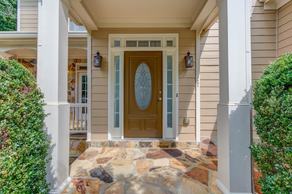 2405 Millwater Crossing Northeast Dacula, GA 30019 - Photo 2 of 63 a front view of a house with garden