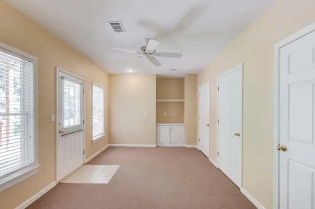 a bathroom with a toilet a sink a mirror a bathtub and vanity