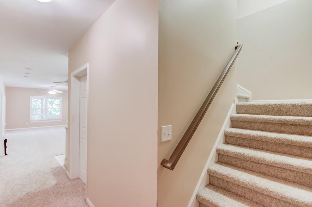 2405 Millwater Crossing Northeast Dacula, GA 30019 - Photo 29 of 63 a view of staircase with white walls and a window
