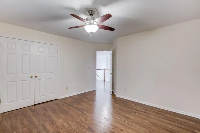 a spacious bathroom with a granite countertop sink a mirror and a shower