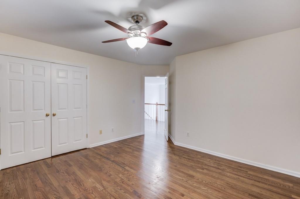 2405 Millwater Crossing Northeast Dacula, GA 30019 - Photo 30 of 63 an empty room with wooden floor and windows