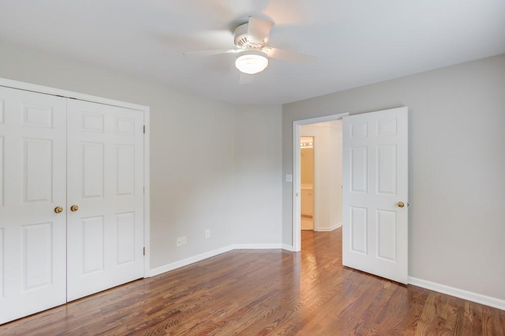 2405 Millwater Crossing Northeast Dacula, GA 30019 - Photo 33 of 63 an empty room with wooden floor and windows