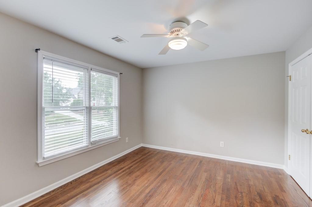 2405 Millwater Crossing Northeast Dacula, GA 30019 - Photo 34 of 63 a view of an empty room with wooden floor and a window