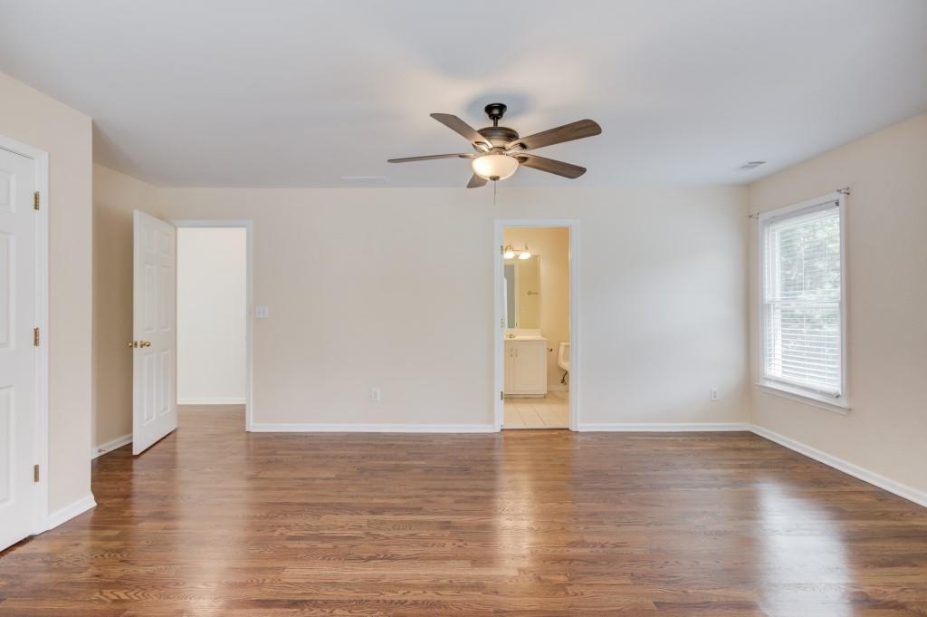2405 Millwater Crossing Northeast Dacula, GA 30019 - Photo 37 of 63 a view of empty room with wooden floor and fan