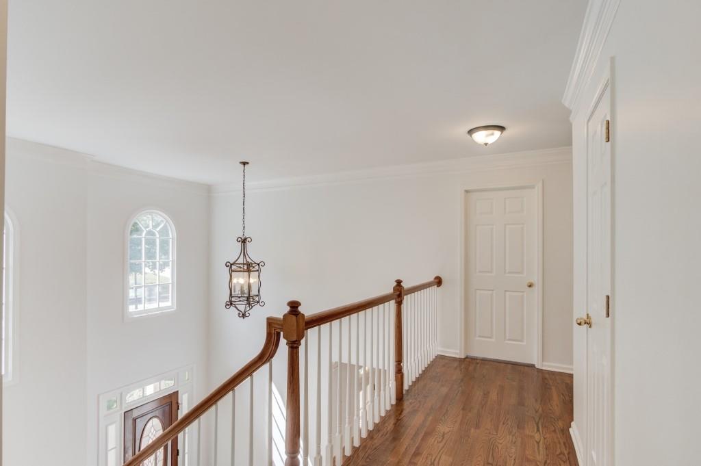 2405 Millwater Crossing Northeast Dacula, GA 30019 - Photo 43 of 63 a view of a hallway with a window and stairs