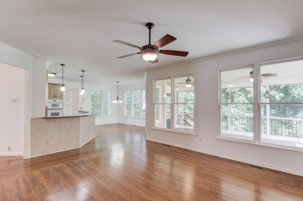 2405 Millwater Crossing Northeast Dacula, GA 30019 - Photo 52 of 63 a view of an empty room with a window and wooden floor