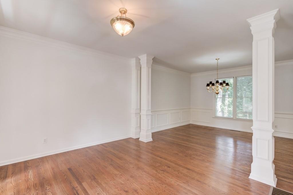2405 Millwater Crossing Northeast Dacula, GA 30019 - Photo 57 of 63 an empty room with wooden floor and windows