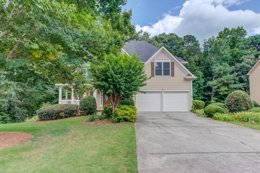 2405 Millwater Crossing Northeast Dacula, GA 30019 - Photo 62 of 63 a house with trees in the background