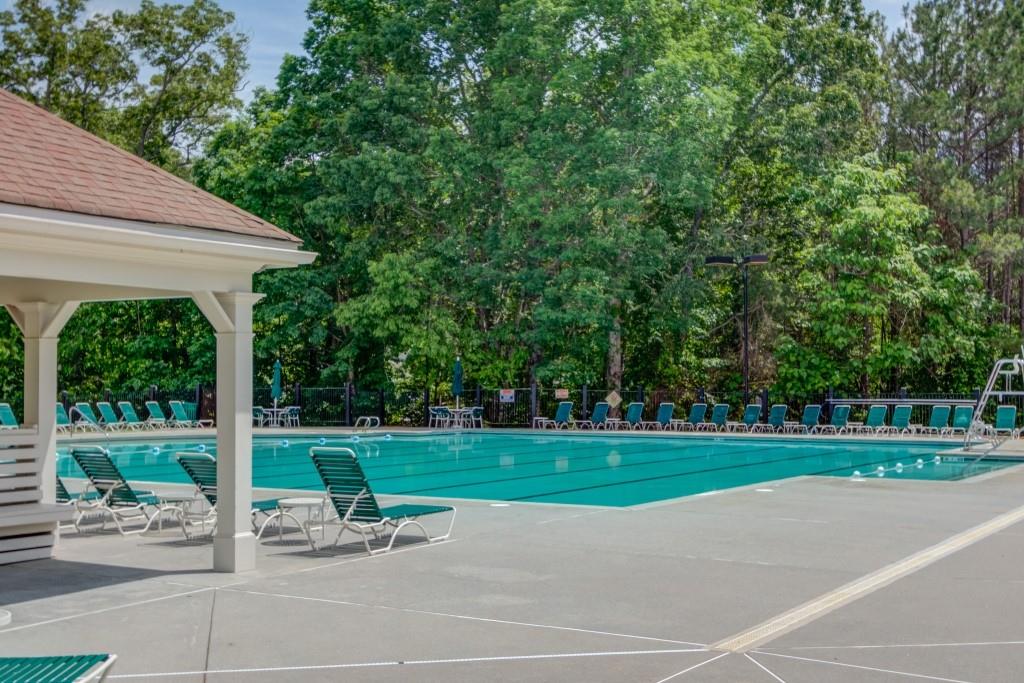 2405 Millwater Crossing Northeast Dacula, GA 30019 - Photo 7 of 63 a view of a table and chairs in backyard of the house