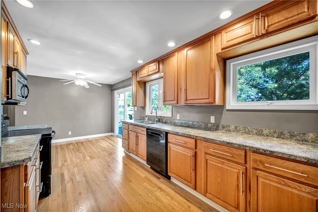 4523 Oakes Road Brecksville, OH 44141 - Photo 15 of 50 Kitchen featuring black appliances, brown cabinets, light wood-type flooring, recessed lighting, and a ceiling fan