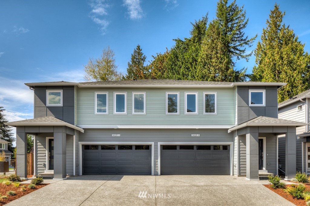 4131 208th Place Southeast, Unit A Bothell, WA 98021 - Photo 1 of 19 a front view of a house with a garage and a yard