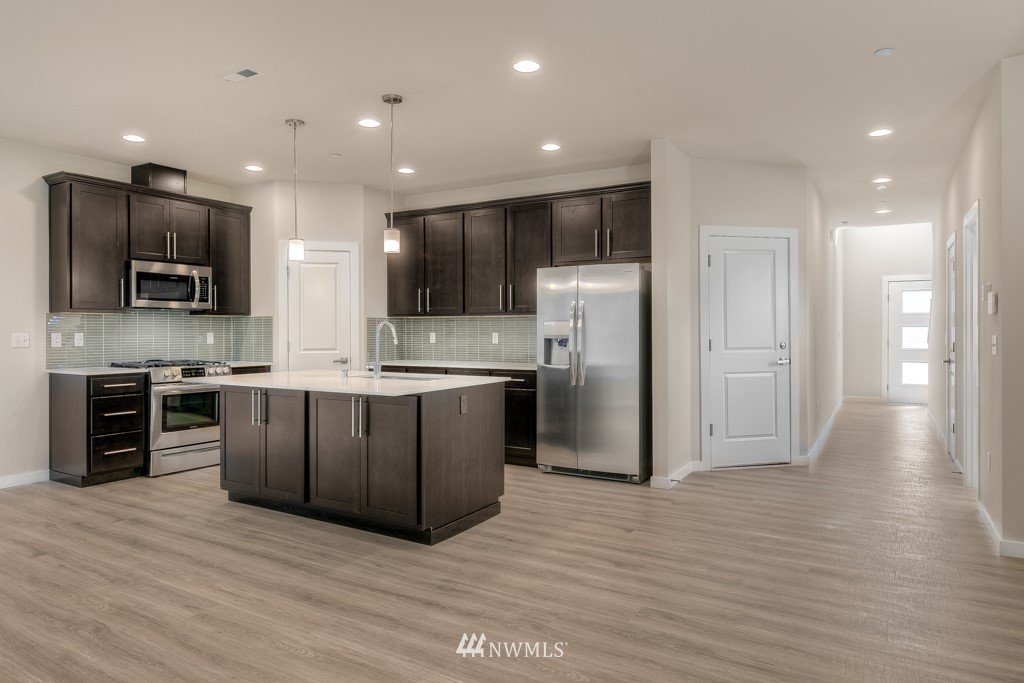 4131 208th Place Southeast, Unit A Bothell, WA 98021 - Photo 7 of 19 a kitchen with stainless steel appliances a refrigerator and a microwave