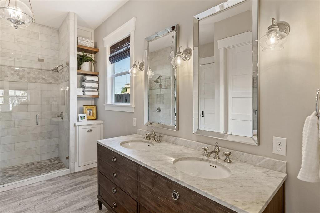 1109 East Oakdale Road Irving, TX 75060 - Photo 11 of 33 a bathroom with a granite countertop shower sink and mirror