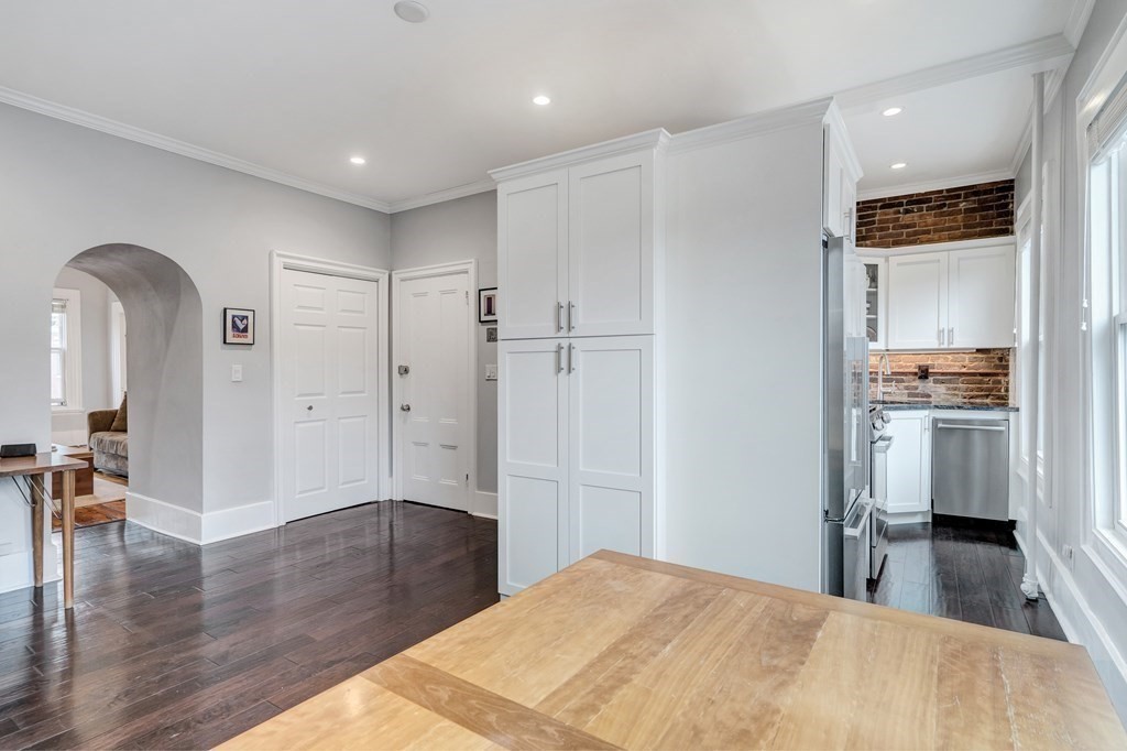 72 Rutland Street, Unit 3 Boston, MA 02118 - Photo 12 of 27 a bedroom with a bed and a view of kitchen