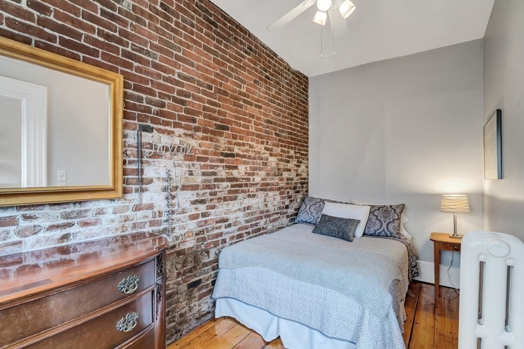 72 Rutland Street, Unit 3 Boston, MA 02118 - Photo 21 of 27 a bedroom with a bed and a chandelier