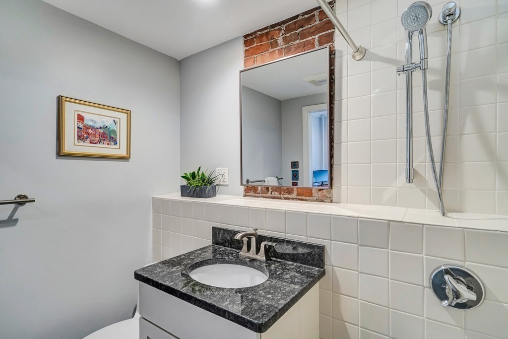 72 Rutland Street, Unit 3 Boston, MA 02118 - Photo 25 of 27 a bathroom with a sink and a mirror
