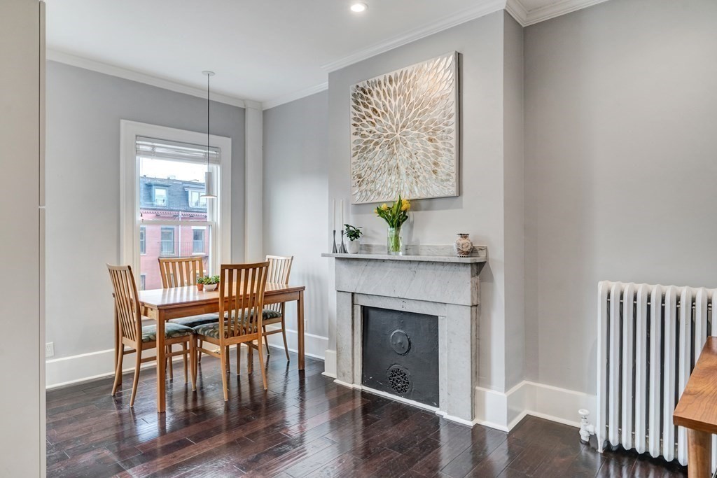 72 Rutland Street, Unit 3 Boston, MA 02118 - Photo 4 of 27 a dining room with furniture a wooden floor and a fireplace