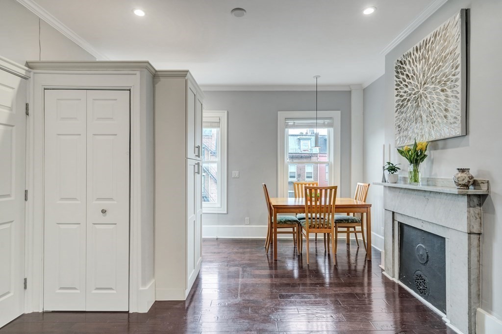 72 Rutland Street, Unit 3 Boston, MA 02118 - Photo 6 of 27 a dining room with furniture wooden floor a fireplace and a window