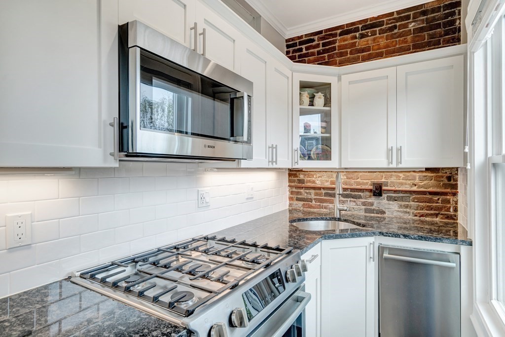 72 Rutland Street, Unit 3 Boston, MA 02118 - Photo 9 of 27 a kitchen with stainless steel appliances a stove and a microwave