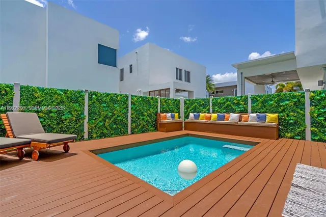 a view of a swimming pool with chairs in patio